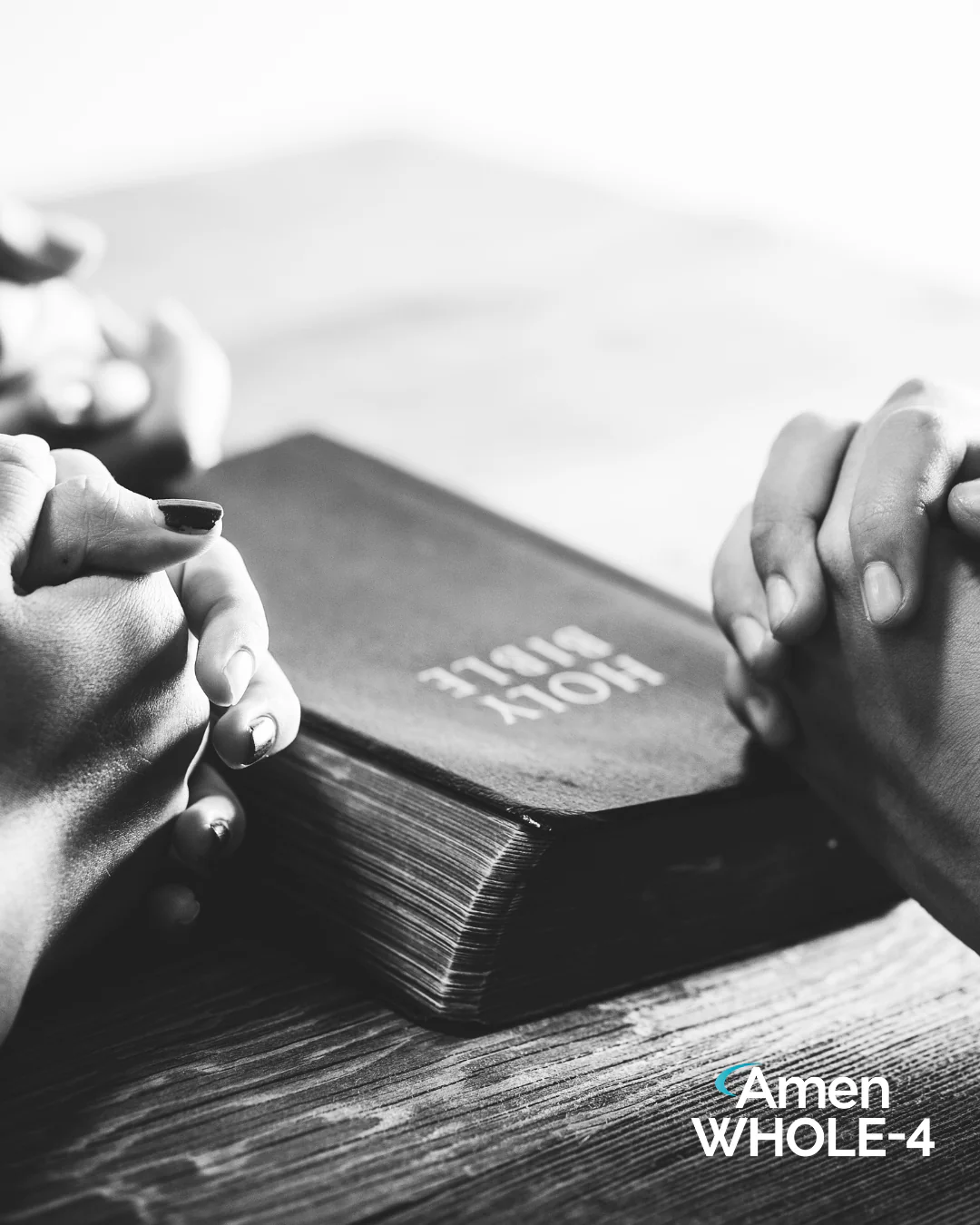 Hands resting on an open Bible